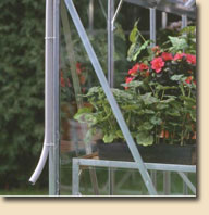 Bolted J-clip secures greenhouse to base 